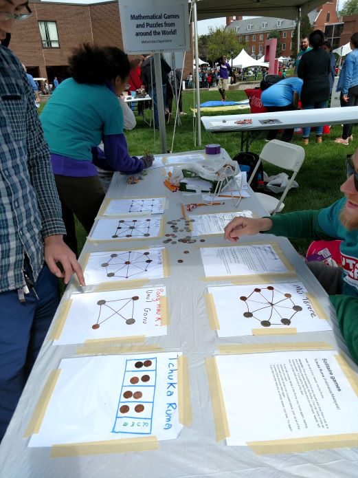A picture of the "Mathematical Games and Puzzles from Around the World!" booth at Rutgers Day 2019